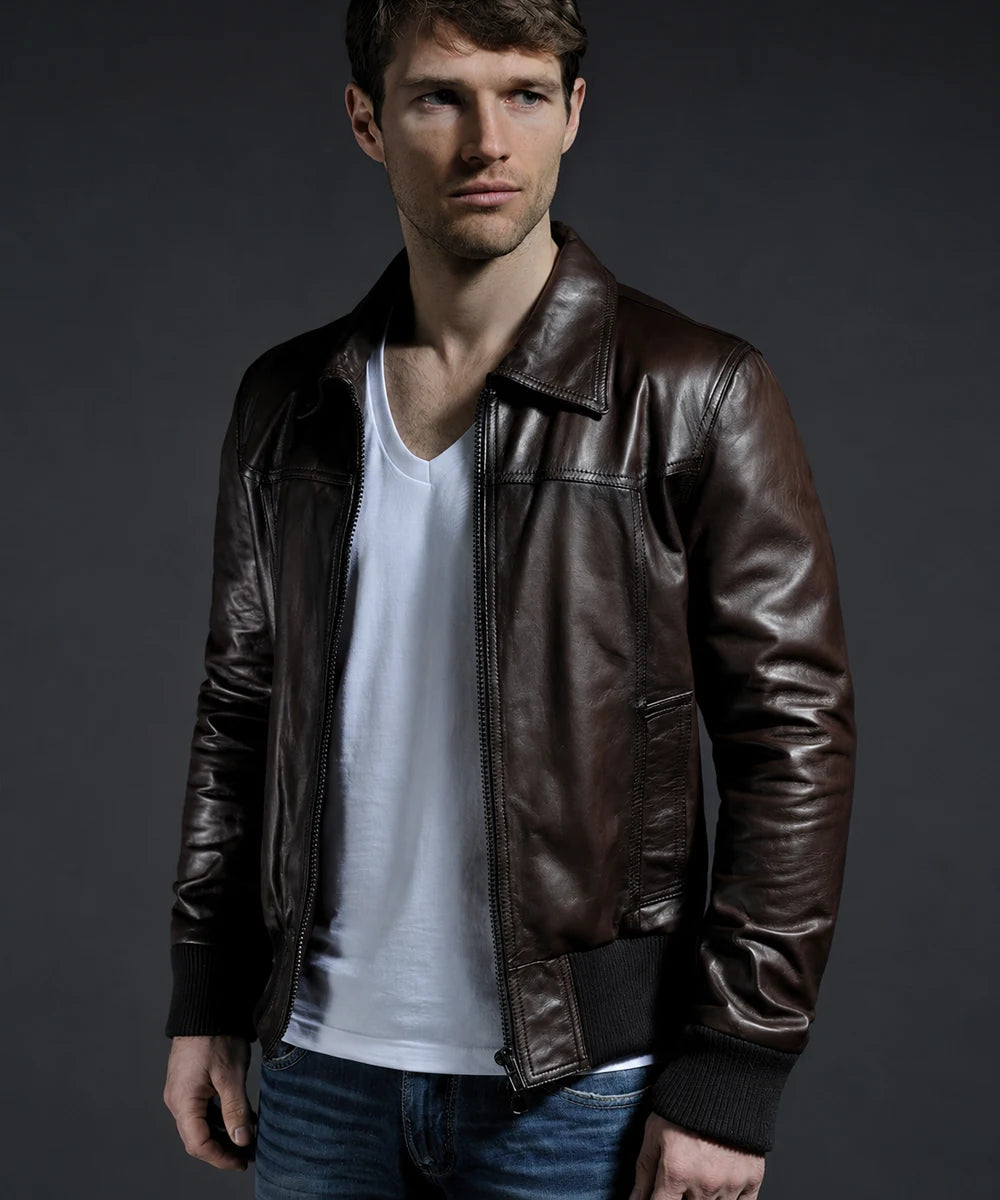 Model wearing vintage brown leather bomber jacket with slim fit styling and ribbed knit trim, worn unzipped
