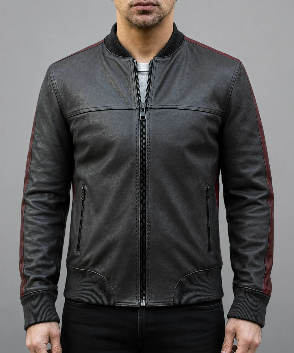 Model wearing vintage black leather bomber jacket with slim fit styling, ribbed knit trim, and contrast red leather detailing