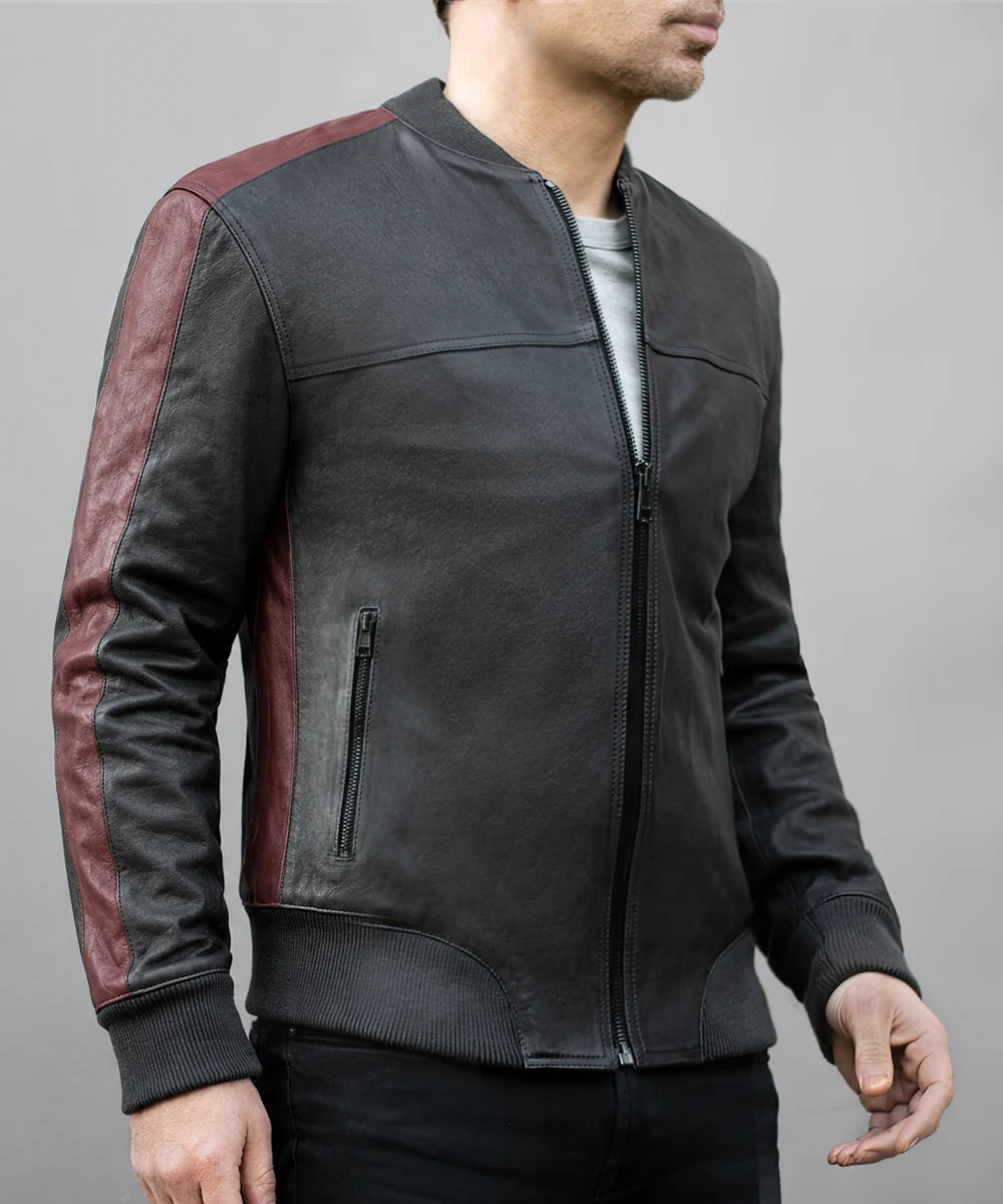 Model wearing vintage black leather bomber jacket with slim fit styling, ribbed knit trim, and contrast red leather detailing